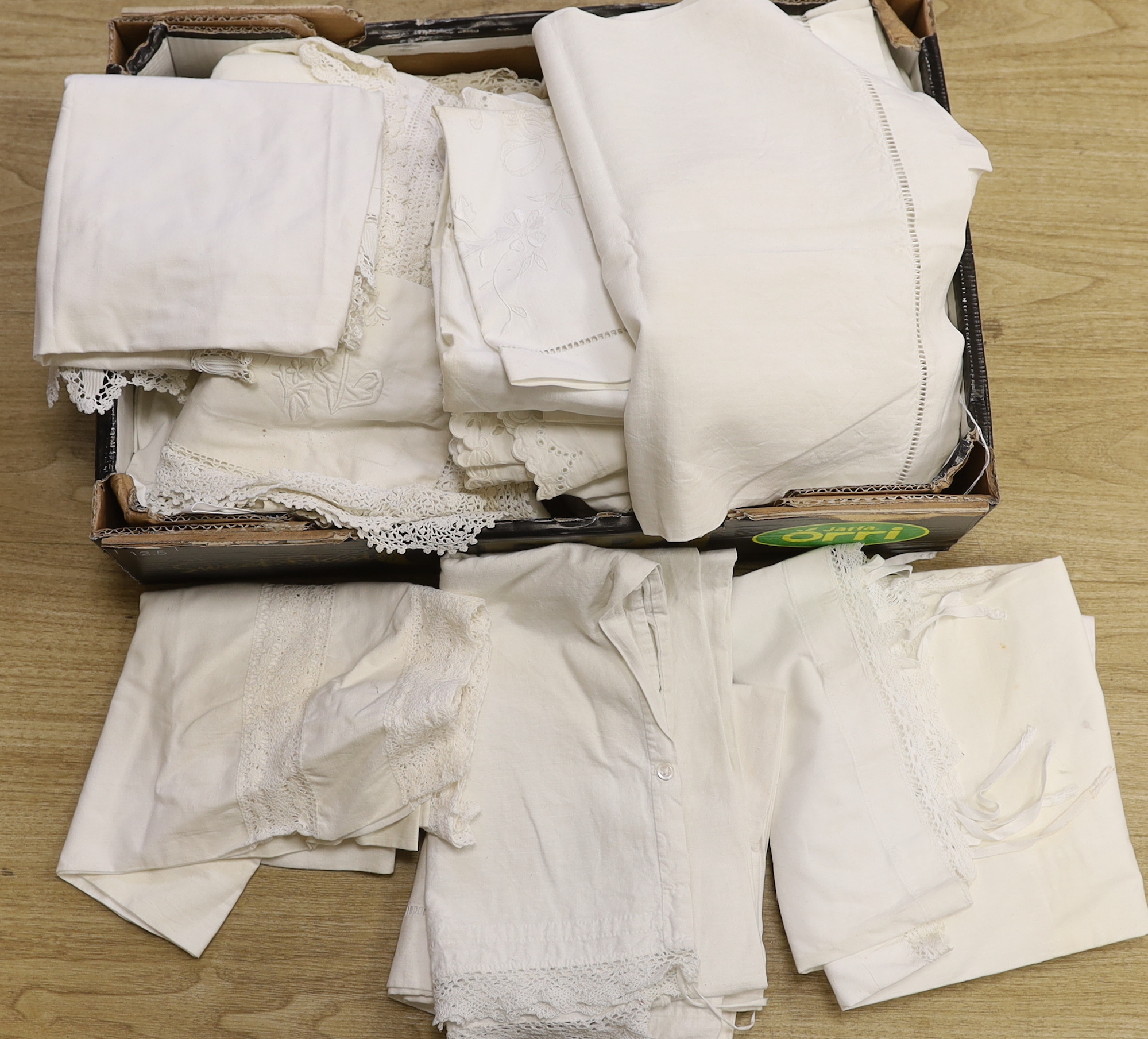 A large collection of French embroidered and crochet edged pillowcases and bolsters, some in pairs